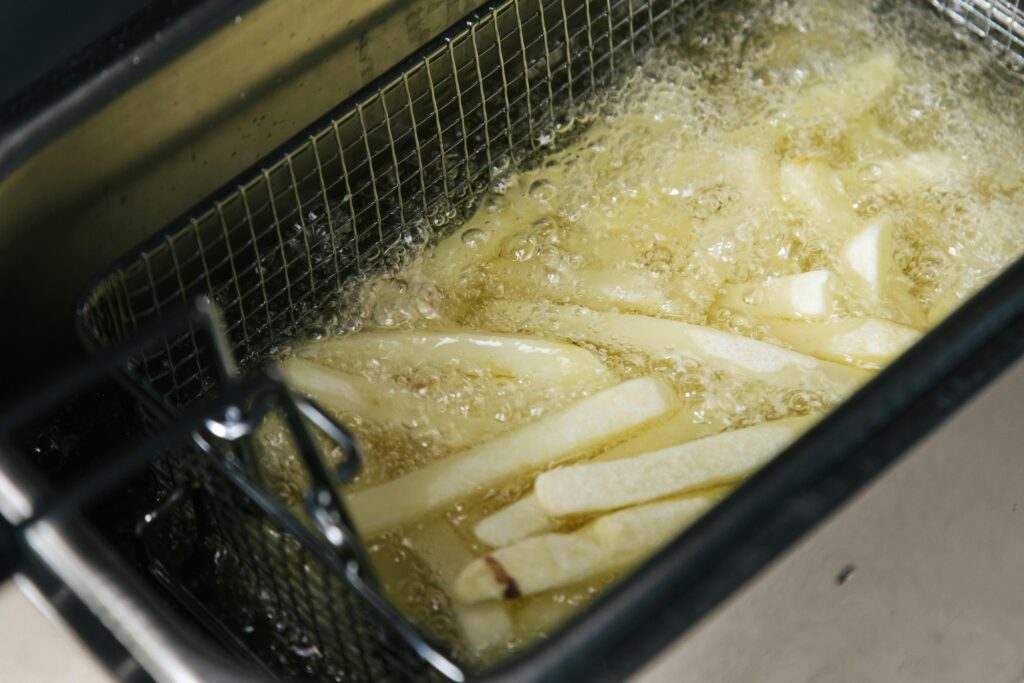 Photograph of French Fries Being Deep Fried