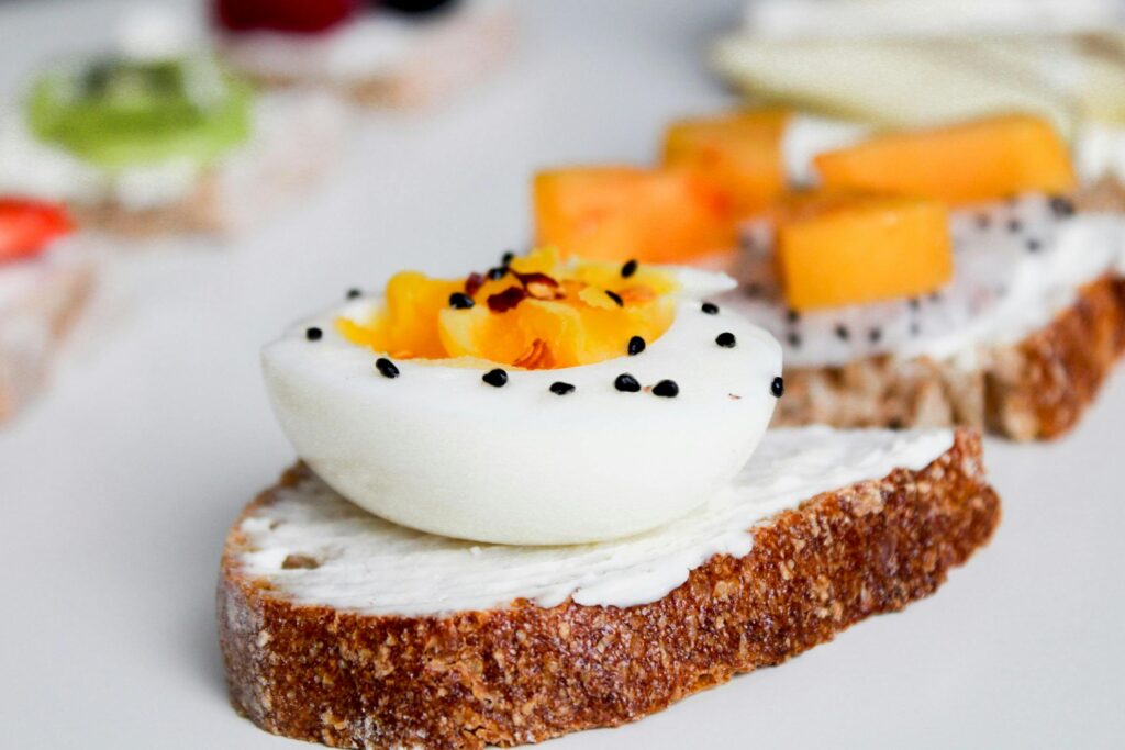 Artful presentation of gourmet egg and fruit toast, perfect for healthy breakfast inspiration.